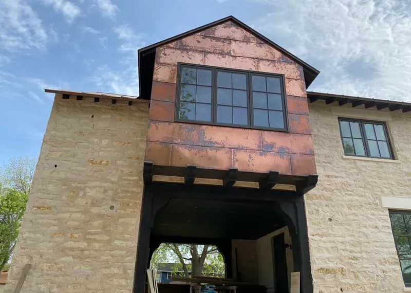 Copper metal panel facade on a stone building for Skylight Installation in Stevensville